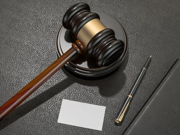 Wooden judges gavel and leather folder on black leather desk — 图库照片