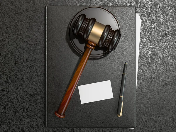 Wooden judges gavel and leather folder on black leather desk — 图库照片