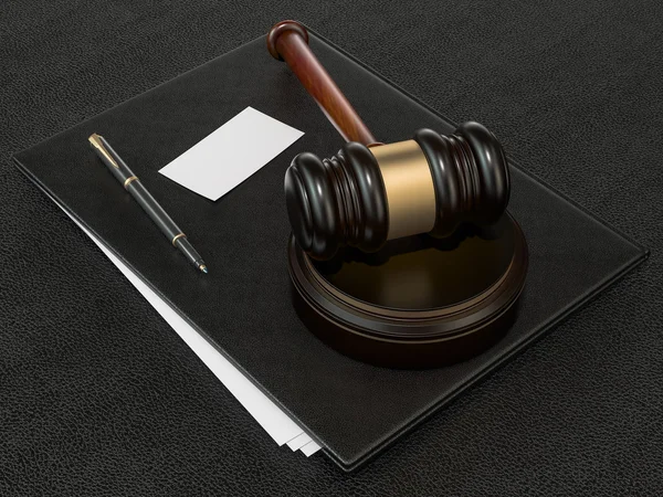 Wooden judges gavel and leather folder on black leather desk — Stock fotografie