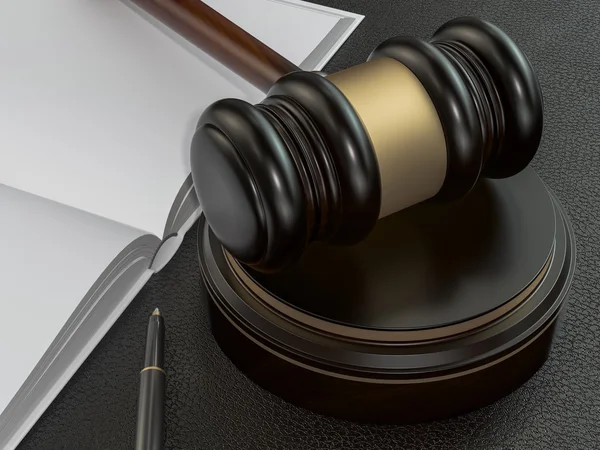 Wooden judges gavel and open book on black leather desk — Stockfoto