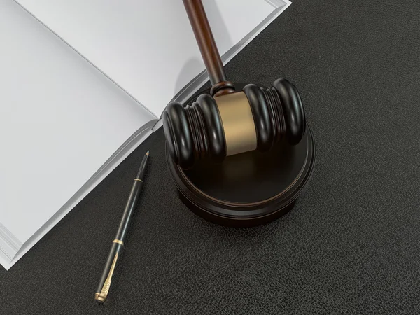 Wooden judges gavel and open book on black leather desk — Stockfoto