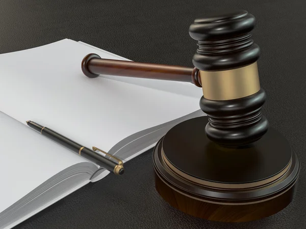 Wooden judges gavel and open book on black leather desk — 스톡 사진