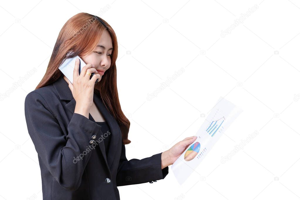 Portrait of young Asian businesswoman talking with colleague on smartphone. Smiling successful female reading paper document with graphs and financial reports. Copy space for text and white background
