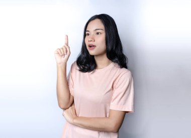 Kızın sorunu çözmek için bir fikri var. Güzel Asyalı kadın parmağını yukarı kaldırıyor. Eureka jestinde genç bir kadının işaret parmağını kaldırması, yeni kavram ve çözümleri tartışması, çözümler imza konsepti