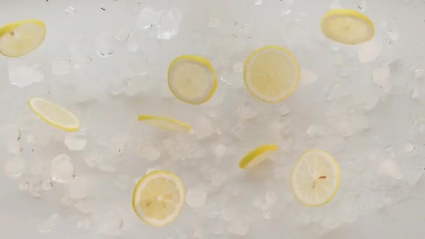 Lemon slices with ice jump and fall for summer lemonade tonic and soda juice — Stock Video