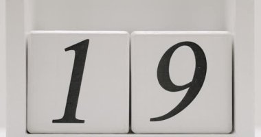 Takvim, geri sayım veya sayısal göstergelerde kullanılmak üzere iki tahta blokta gösterilen 19 sayısının yakın plan görüntüsü. Minimalist ve modern tasarım.