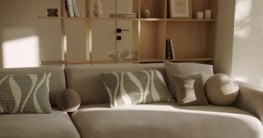 Güzel bir sabah ışığı ve gölgeler rahat bir kanepede rahat, modern bir oturma odasında rahat ve huzurlu bir atmosfer yaratarak rahatlama ve iç tasarım kavramları yaratıyor.