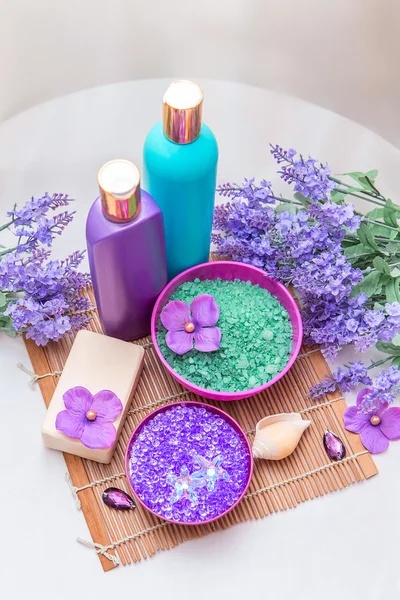 Bathroom interior decor with sea salt, some bottles and soap. Lavender and purple color hygiene products and accessories. — Stock Photo, Image