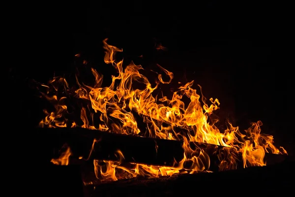 bright fire texture on black background. yellow and orange flames of fire