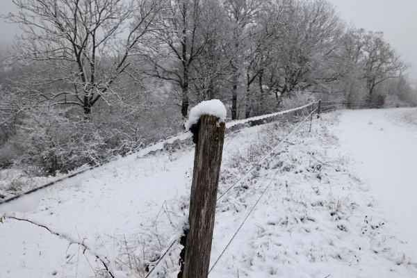 Winter landscape with an electric fence in the foreground.