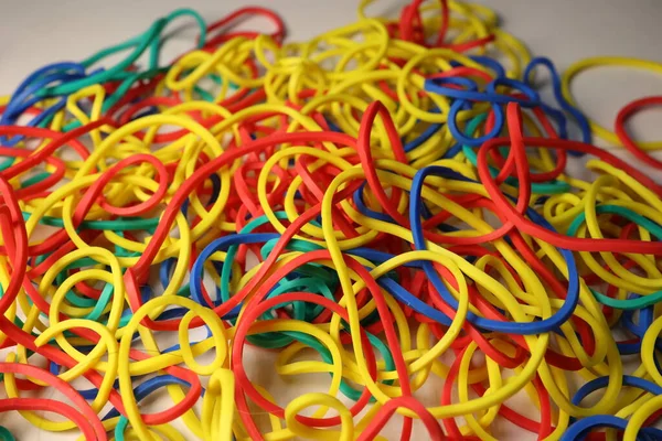 Multi-colored elastic band rubber scattered on the table.