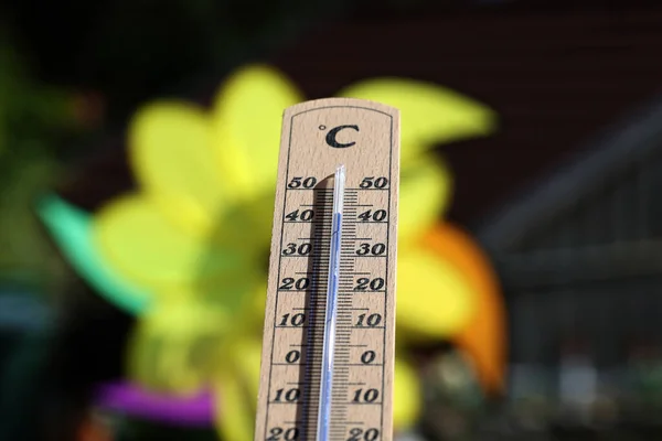 Thermometer shows high temperatures on a hot summer day.