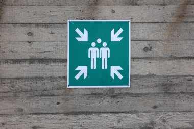 A sign on the wall indicates the gathering place.