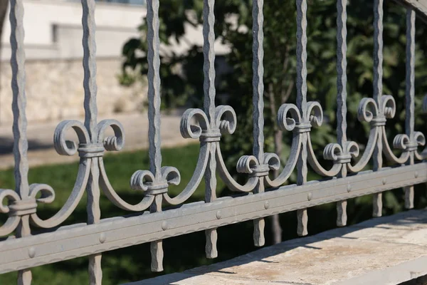 Metal fence. Metal curly fence in the park.