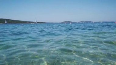 Saf berrak deniz suyu sabah güneşinde parıldar.