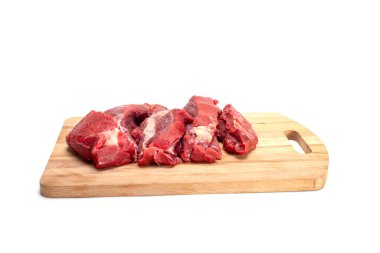 Fresh raw beef on a wooden board, cut isolated on white.