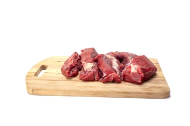 Fresh raw beef on a wooden board, cut isolated on white.