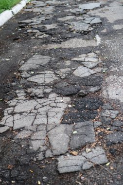 İmha edilmiş yol kötü durumda ve onarılması gerekiyor. Asfalttaki delikler su ve su birikintileriyle dolu. Stok fotoğraf arkaplanı