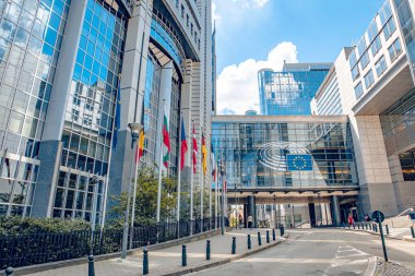 Brussels, Belgium - July 20, 2020: European Parliament offices and European flags. clipart