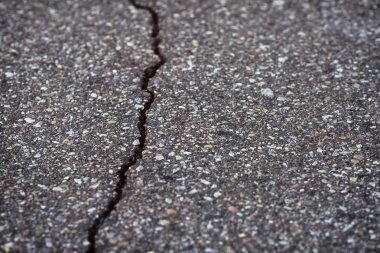 Close-Up texture of damaged asphalt road surface clipart