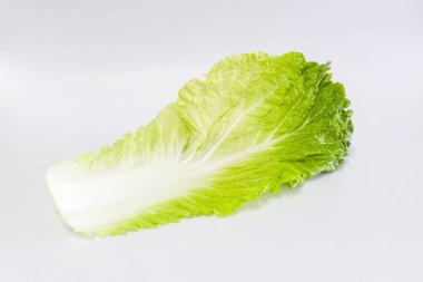 Close-up lettuce green leaves for salad, isolated on a white background
