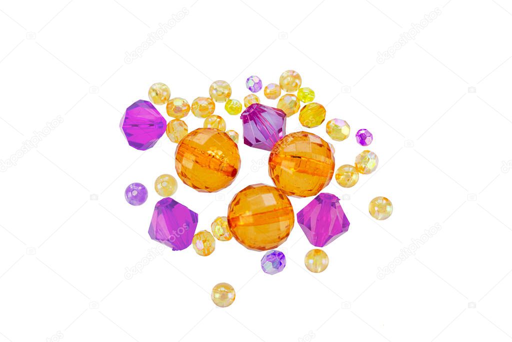 A layout of orange and yellow beads isolated on a white background. Selected focus.Supplies for hand made proccess.