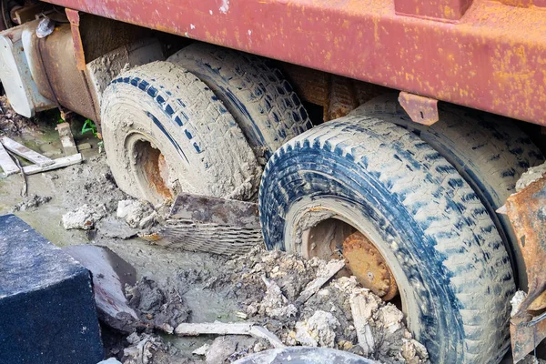 The rear wheels of the three-axis truck got stuck in the mud after the deluge. Traces of slipping.