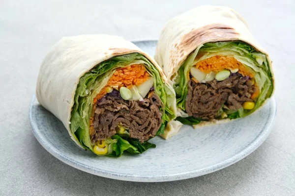 Salad Wrap. Tortilla wraps with beef teriyaki and fresh vegetables. Close up and selective focus image.