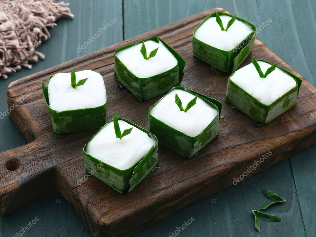 Kue Talam, Traditional cake made from coconut milk, rice flour, and tapioca flour. Garnish with pandan leaf served on fresh green pandan leaf.