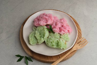 Kue Bikang veya Carabikang, Endonezya 'nın Merkez Java kentinde pirinç unu ve hindistan cevizi sütünden yapılan geleneksel keklerden biridir. Tabakta servis edildi. Boşluğu kopyala.