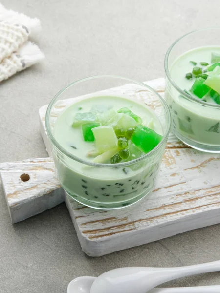 Buko Pandan, a dessert from Philippines, made from jelly, young coconut, evaporated milk, sweetened condensed milk, and ice. Served on glass. Selective focus.