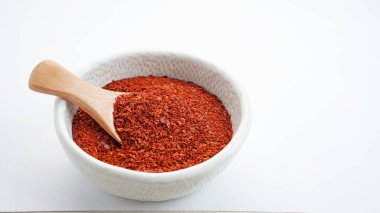 Gochugaru in bowl with wooden spoon, Korean organic hot chili pepper