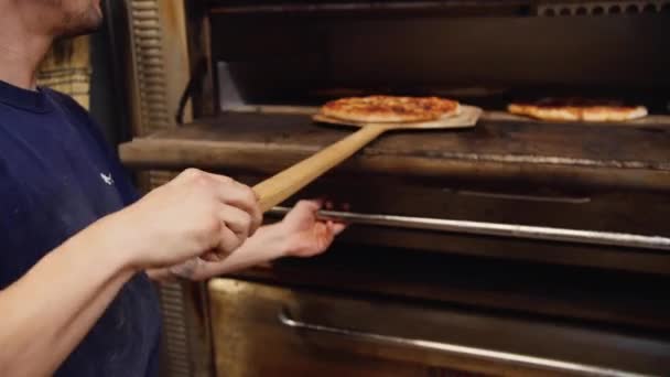 Een persoon die kookt in de oven — Stockvideo