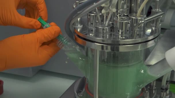 機械から緑色の液体を注入する手の終わり — ストック動画