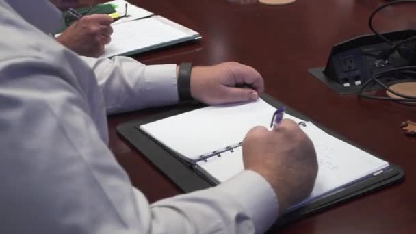 A man sitting at a table with a knife — Stock Video