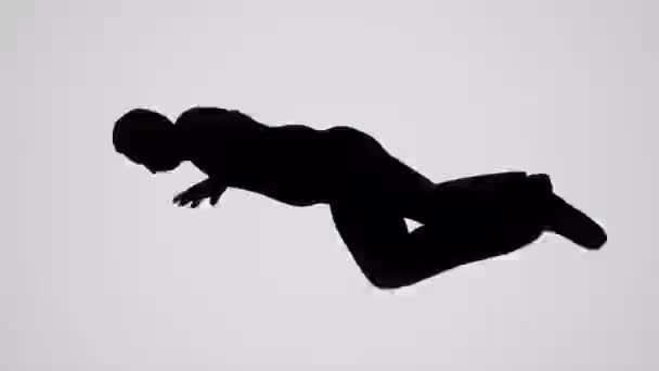 A Silhouetted man falling on white background — Stock Video