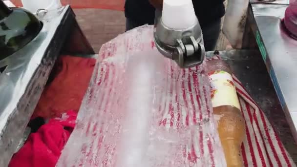 A Shaving ice off of ice block for snow cones — Stock video