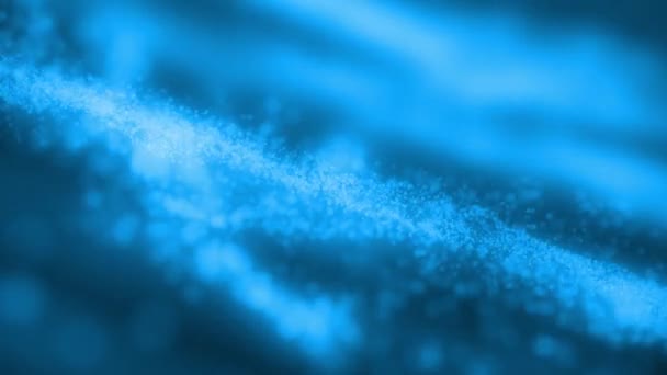 Une onde de particules bleues qui coule avec de la poussière de particules — Video