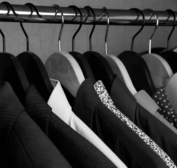 shirts and jackets in wardrobe isolated closeup