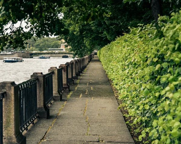 Bridge at railing along the river in summer cloudy day — Stock Photo, Image