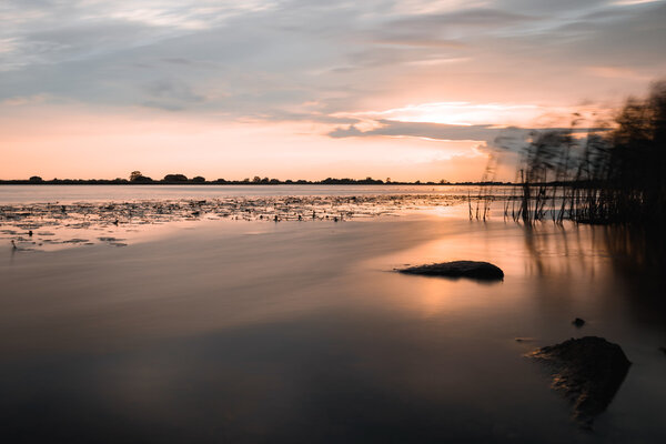 summer sunset on the lake after rain