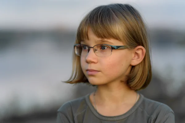 Triste adolescente avec les cheveux blonds courts et les yeux bleus contre le ciel du soir — Photo