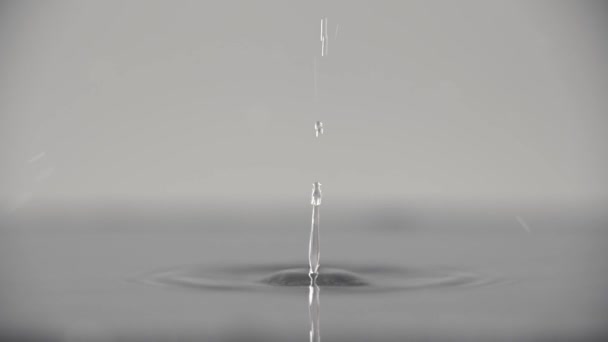 Video Slow Motion Dripping Water Drop Diverging Circles Grey Background — Wideo stockowe