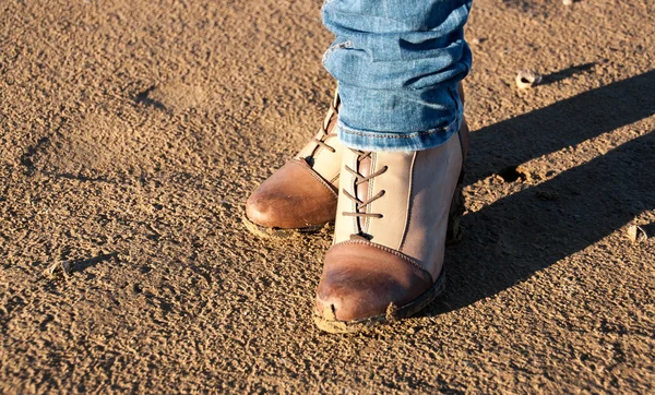 Conceptual image of legs in boots on the autumn — Stock Photo, Image