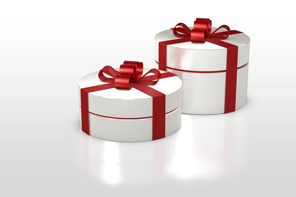 Witte ronde geschenkdoos met rood lint — Stockfoto