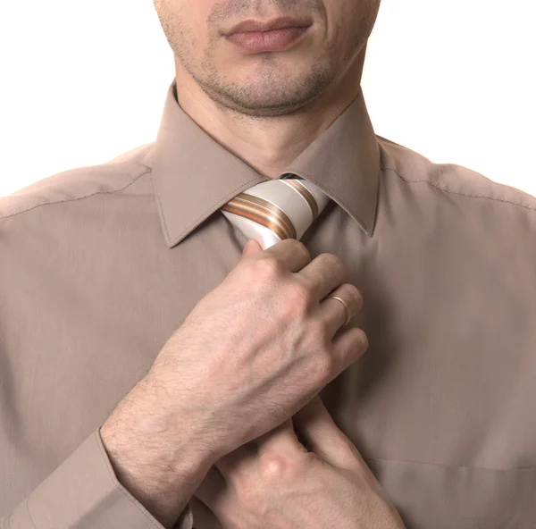 Hombre de negocios endereza su corbata primer plano sobre fondo blanco —  Fotos de Stock