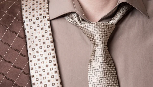 Zakenman selecteert een stropdas close-up op witte achtergrond — Stockfoto