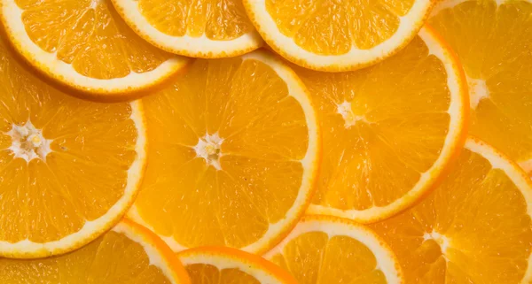 Slices of oranges laid out in the form background Stock Image