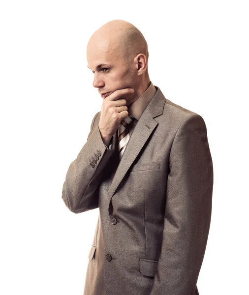 Hombre de negocios en un traje pensando en fondo blanco Imágenes de stock libres de derechos