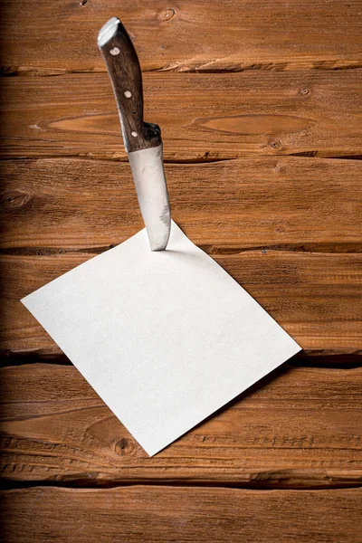 Old Vintage Metal Knife Stuck Blank Notepad Page Wooden Table — Stock Photo, Image